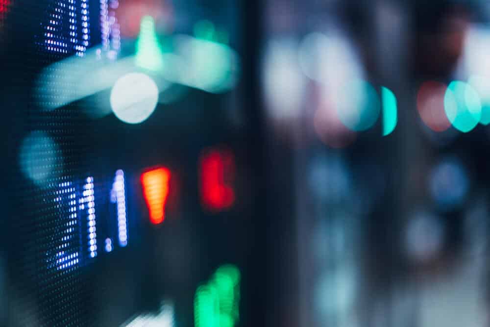 Display stock market numbers with defocused street lights background.